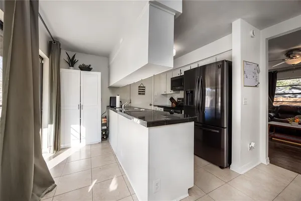 a kitchen with stainless steel appliances a sink stove and refrigerator