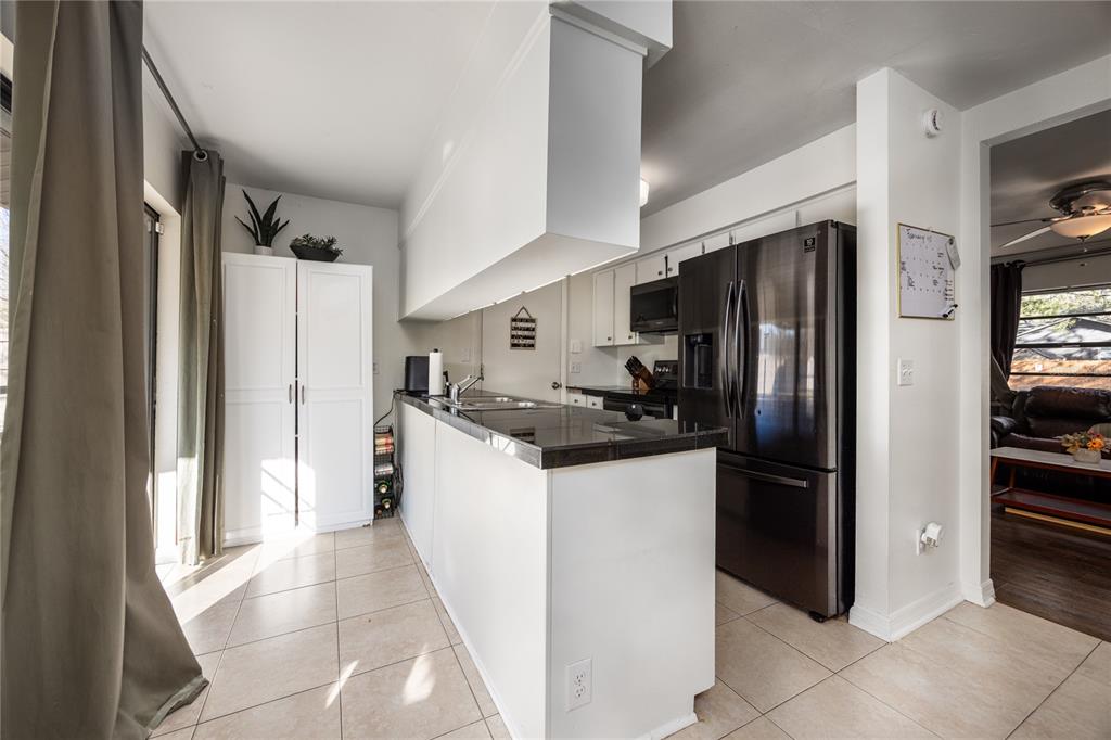 8031 Southwest 13th Road Gainesville, FL 32607 - Photo 13 of 40 a kitchen with a refrigerator and a sink