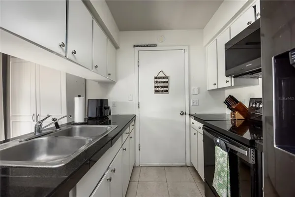 a kitchen with stainless steel appliances a sink stove and cabinets