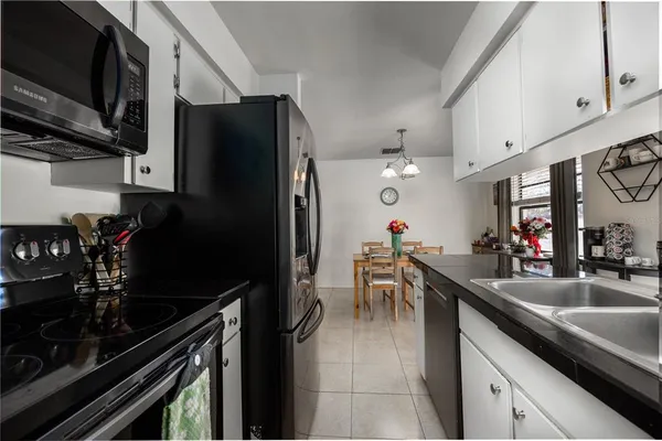 a kitchen with a sink and a refrigerator