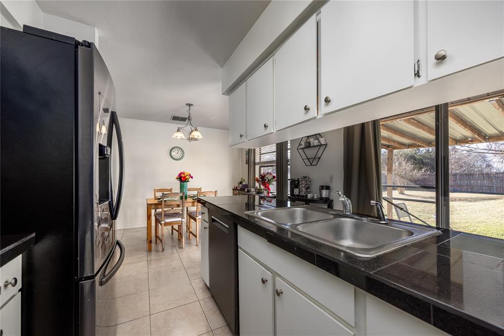 8031 Southwest 13th Road Gainesville, FL 32607 - Photo 17 of 40 a kitchen with a sink and a refrigerator
