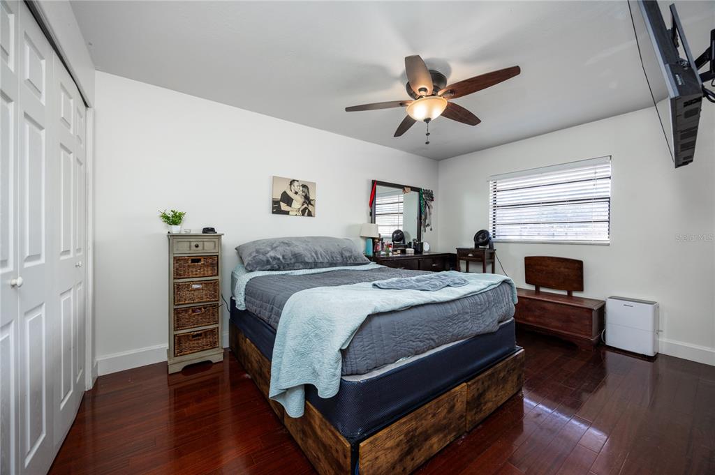 8031 Southwest 13th Road Gainesville, FL 32607 - Photo 18 of 40 a bedroom with a bed and a chandelier