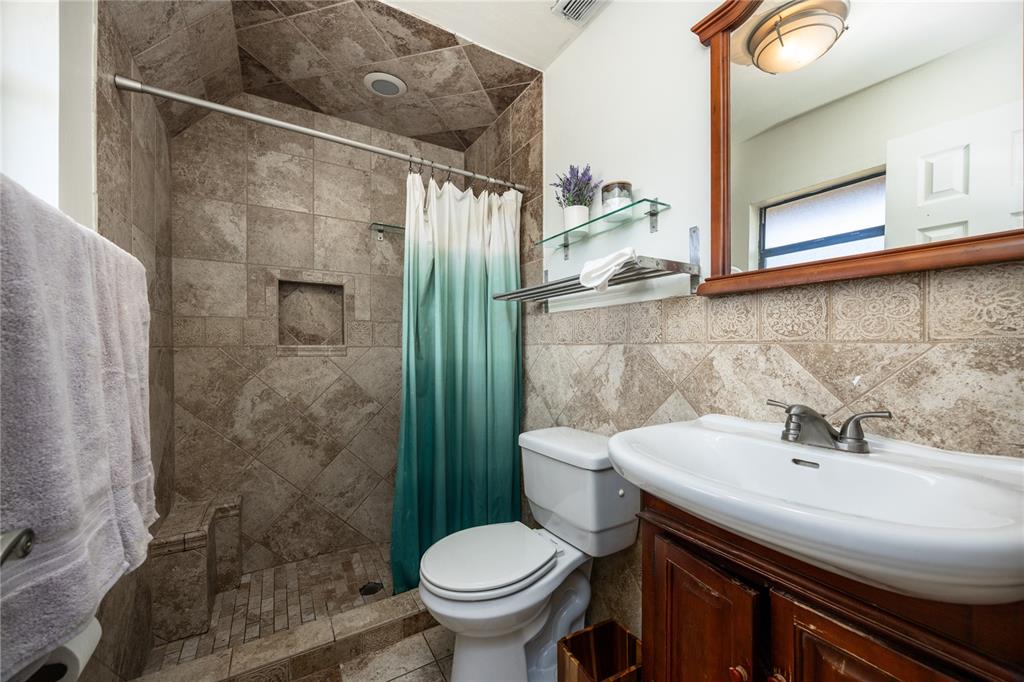 8031 Southwest 13th Road Gainesville, FL 32607 - Photo 20 of 40 a bathroom with a sink toilet and shower