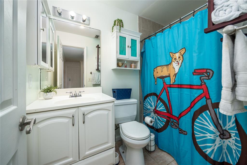 8031 Southwest 13th Road Gainesville, FL 32607 - Photo 23 of 40 a bathroom with a sink a toilet and a mirror