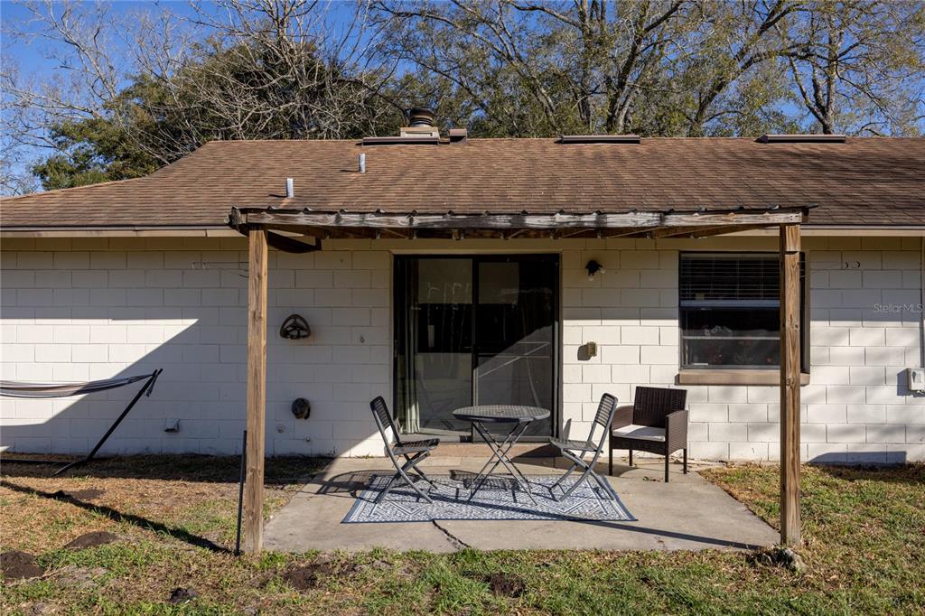 8031 Southwest 13th Road Gainesville, FL 32607 - Photo 25 of 40 a backyard of a house with table and chairs