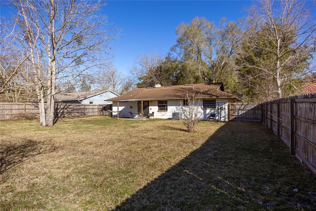 8031 Southwest 13th Road Gainesville, FL 32607 - Photo 30 of 40 a view of a house with backyard and trees