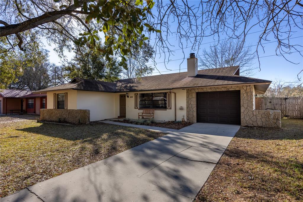 8031 Southwest 13th Road Gainesville, FL 32607 - Photo 38 of 40 a front view of a house with a yard and garage