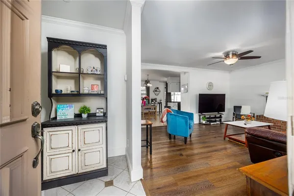 a living room with furniture and a large mirror