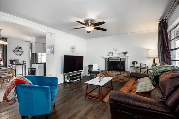 a living room with furniture a fireplace and a flat screen tv