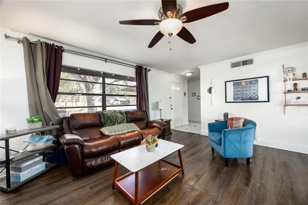 a living room with furniture and wooden floor