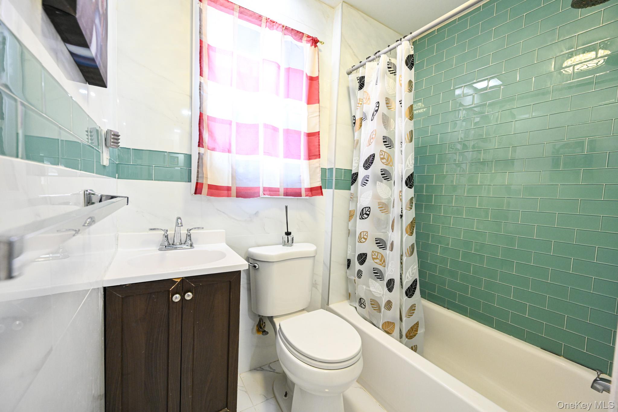 176-25 133rd Road Queens, NY 11434 - Photo 11 of 15 a bathroom with a sink toilet and shower