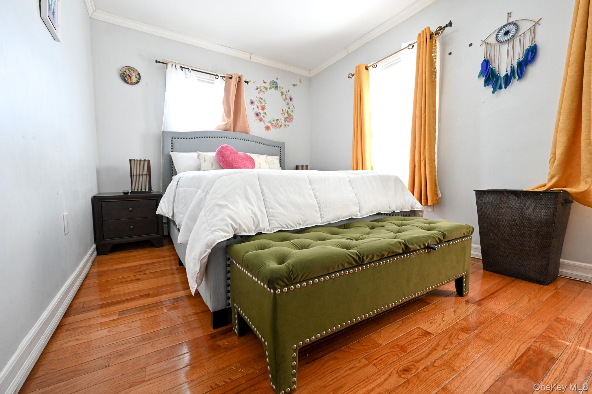 176-25 133rd Road Queens, NY 11434 - Photo 13 of 15 a bed sitting in a bedroom next to a window with a rug and a couch
