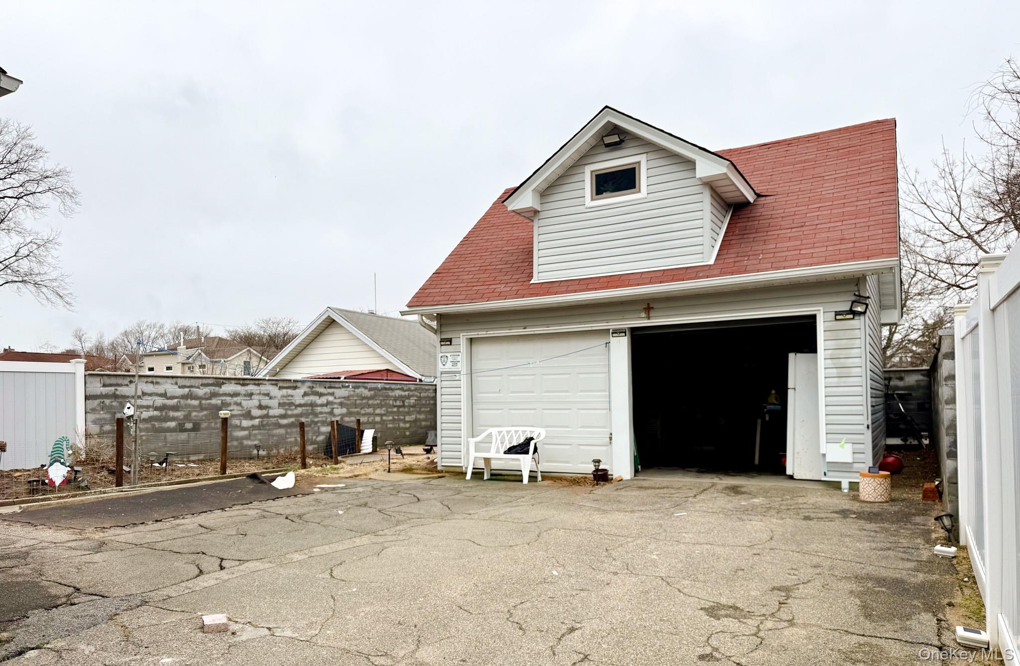 176-25 133rd Road Queens, NY 11434 - Photo 5 of 15 a front view of a house with a yard and garage