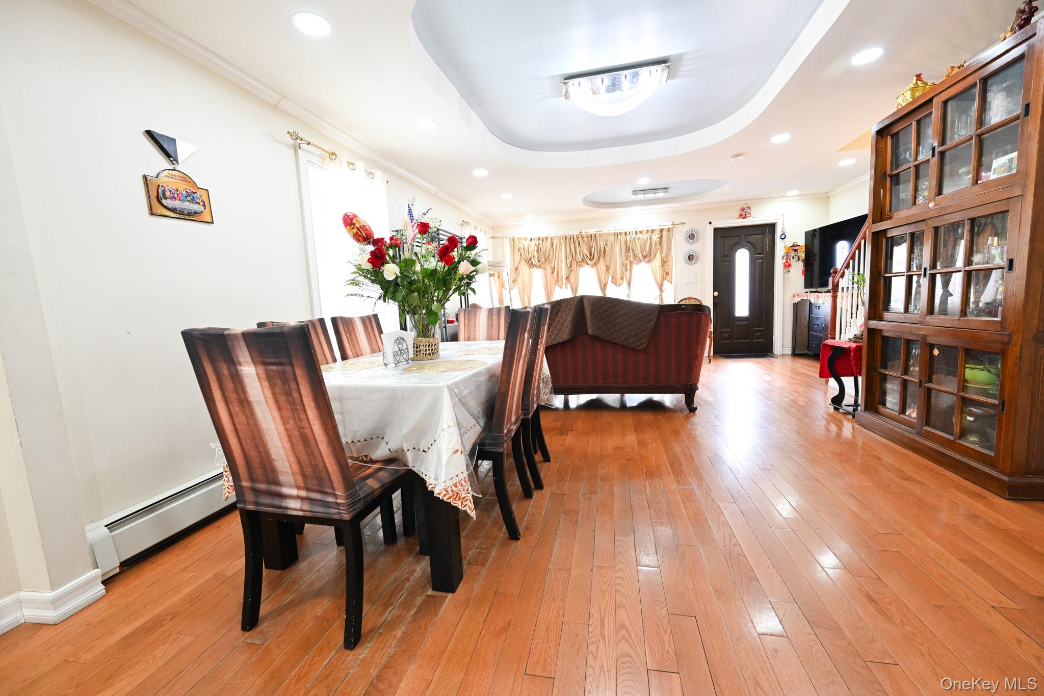 176-25 133rd Road Queens, NY 11434 - Photo 8 of 15 a view of a dining room with furniture and a book shelf