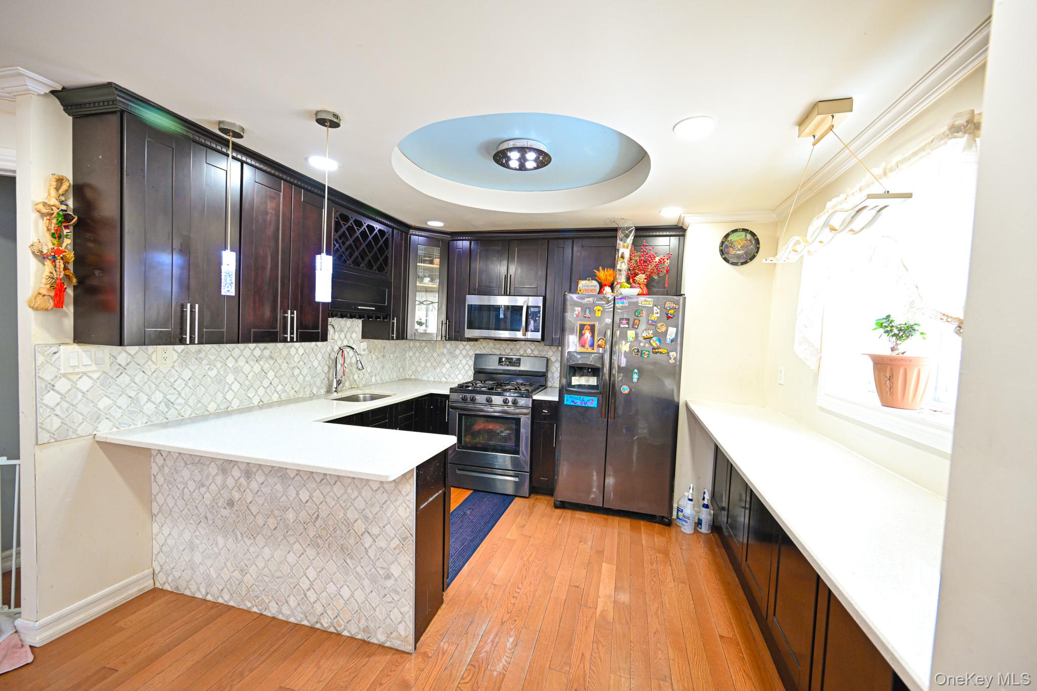 176-25 133rd Road Queens, NY 11434 - Photo 9 of 15 a kitchen that has a lot of cabinets and wooden floor