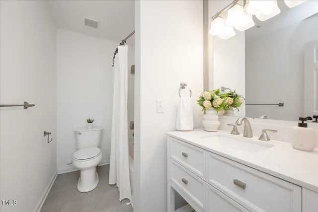 a bathroom with a sink a toilet and a large mirror