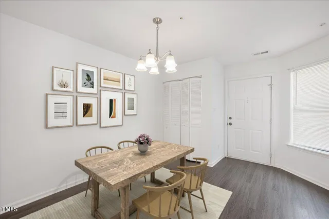 a view of a dining room with furniture wooden floor and chandelier