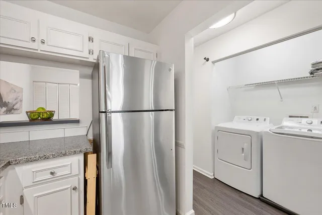 a kitchen with a refrigerator sink and white cabinets