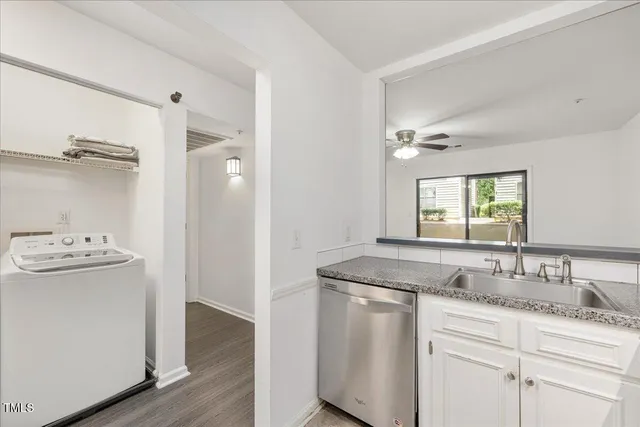 a bathroom with a granite countertop double vanity sink and mirror