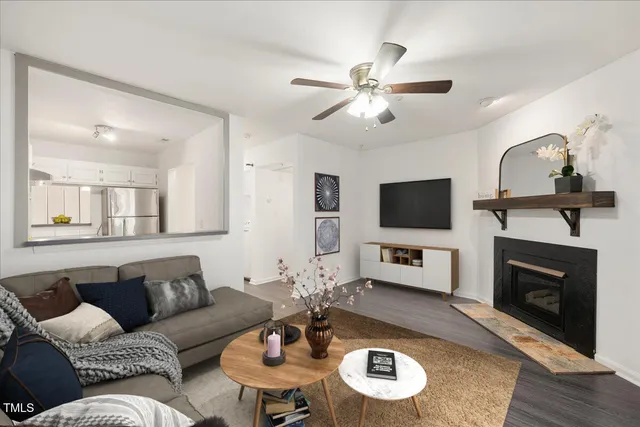 a living room with furniture a fireplace and a flat screen tv