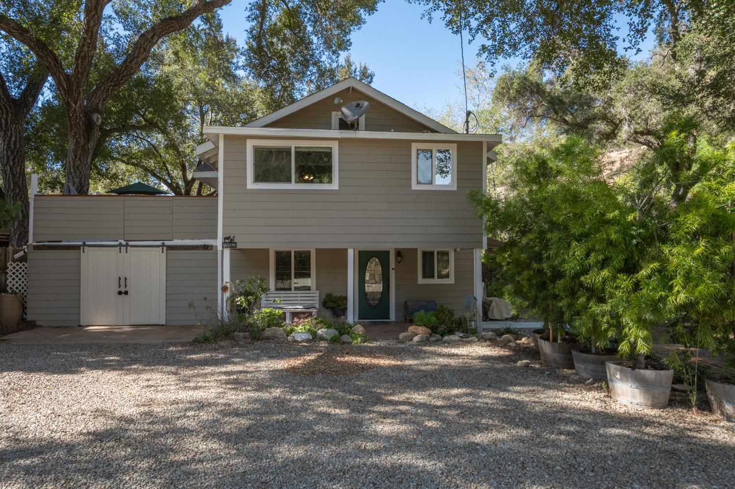 15663 Ojai Road Santa Paula, CA 93060 - Photo 1 of 47 a front view of a house with a yard and garage
