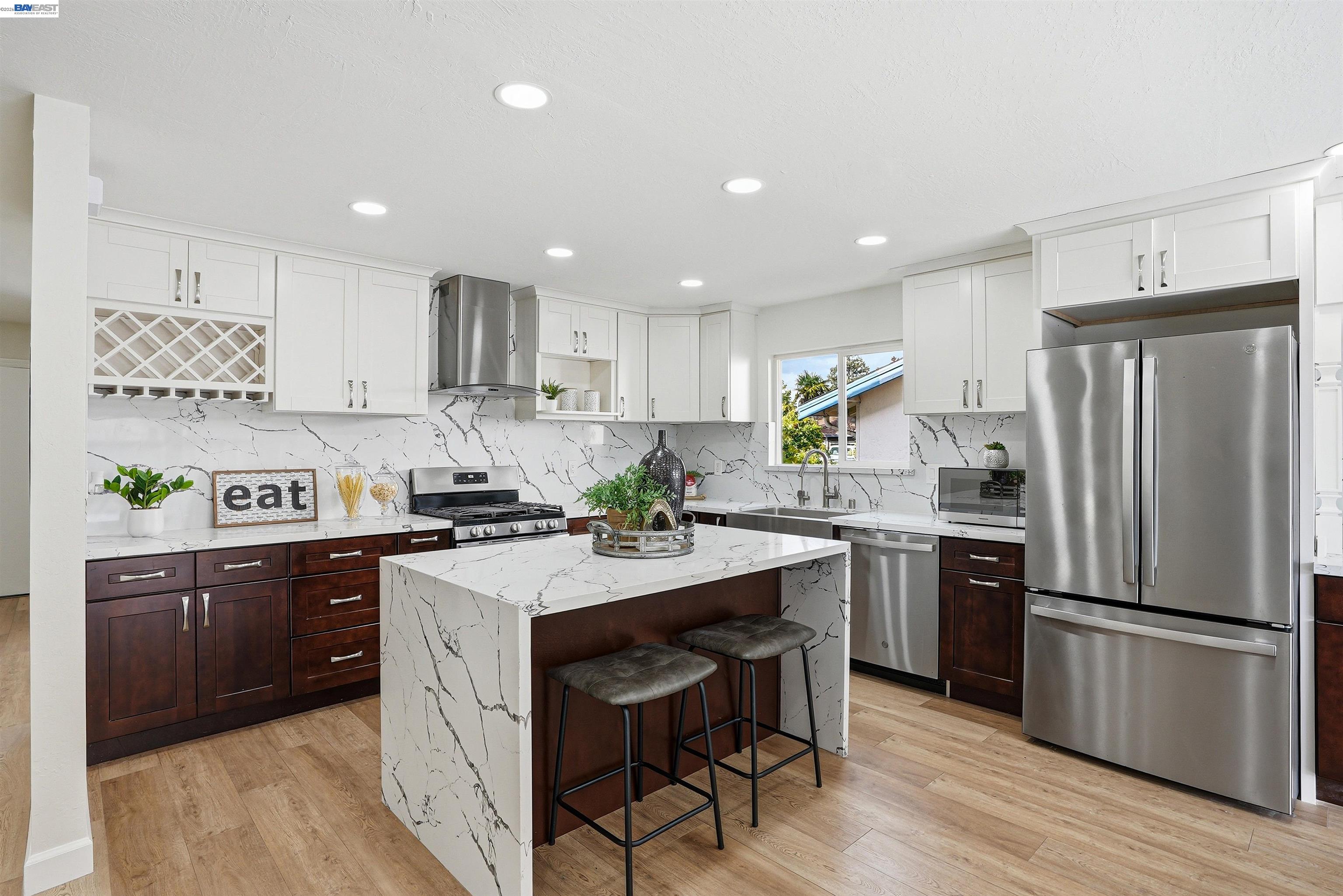6738 Rancho Court Pleasanton, CA 94588 - Photo 12 of 33 a kitchen with refrigerator a sink and chairs