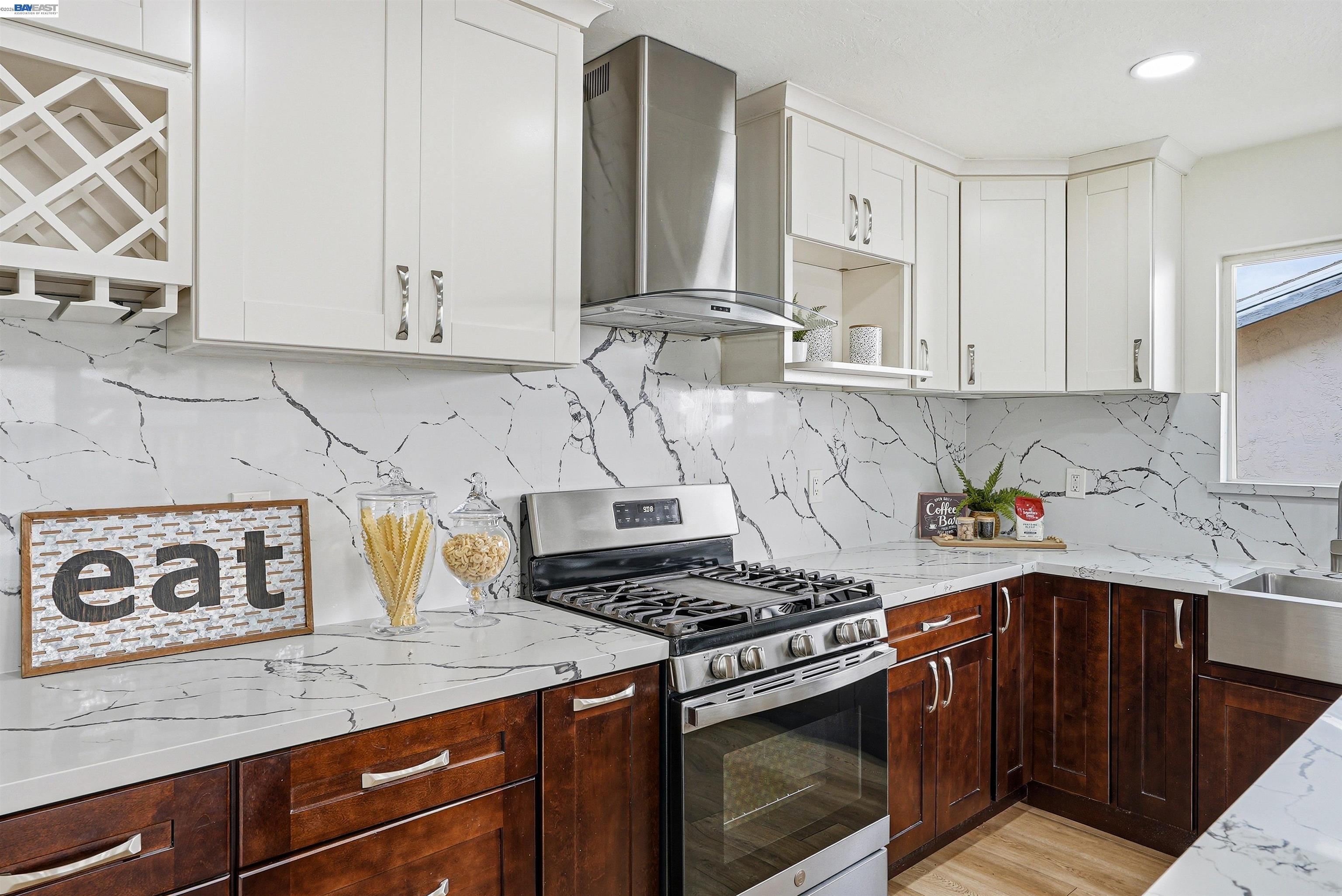 6738 Rancho Court Pleasanton, CA 94588 - Photo 15 of 33 a kitchen with granite countertop a stove sink and cabinets
