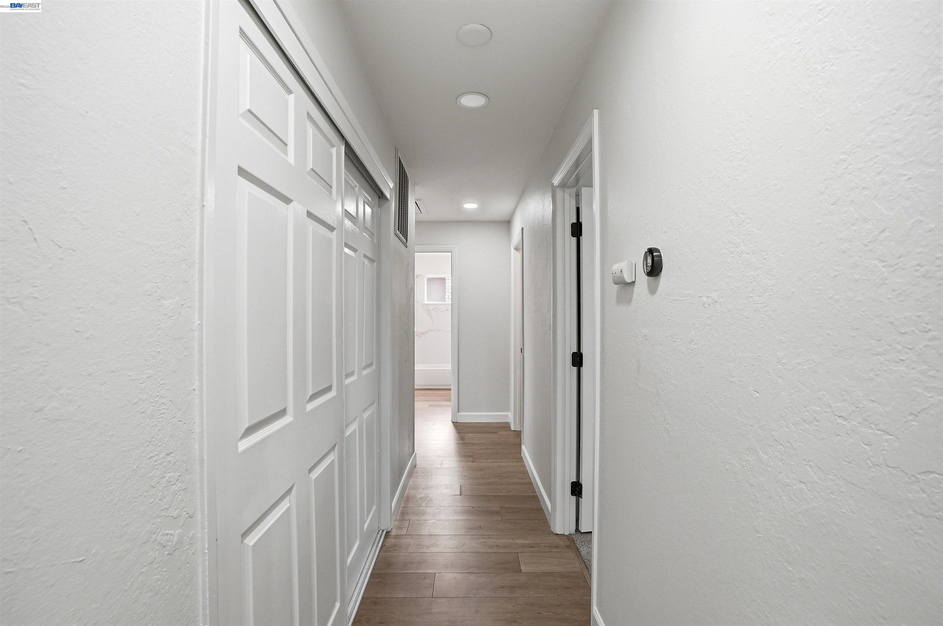 6738 Rancho Court Pleasanton, CA 94588 - Photo 16 of 33 a view of a hallway with wooden floor and staircase