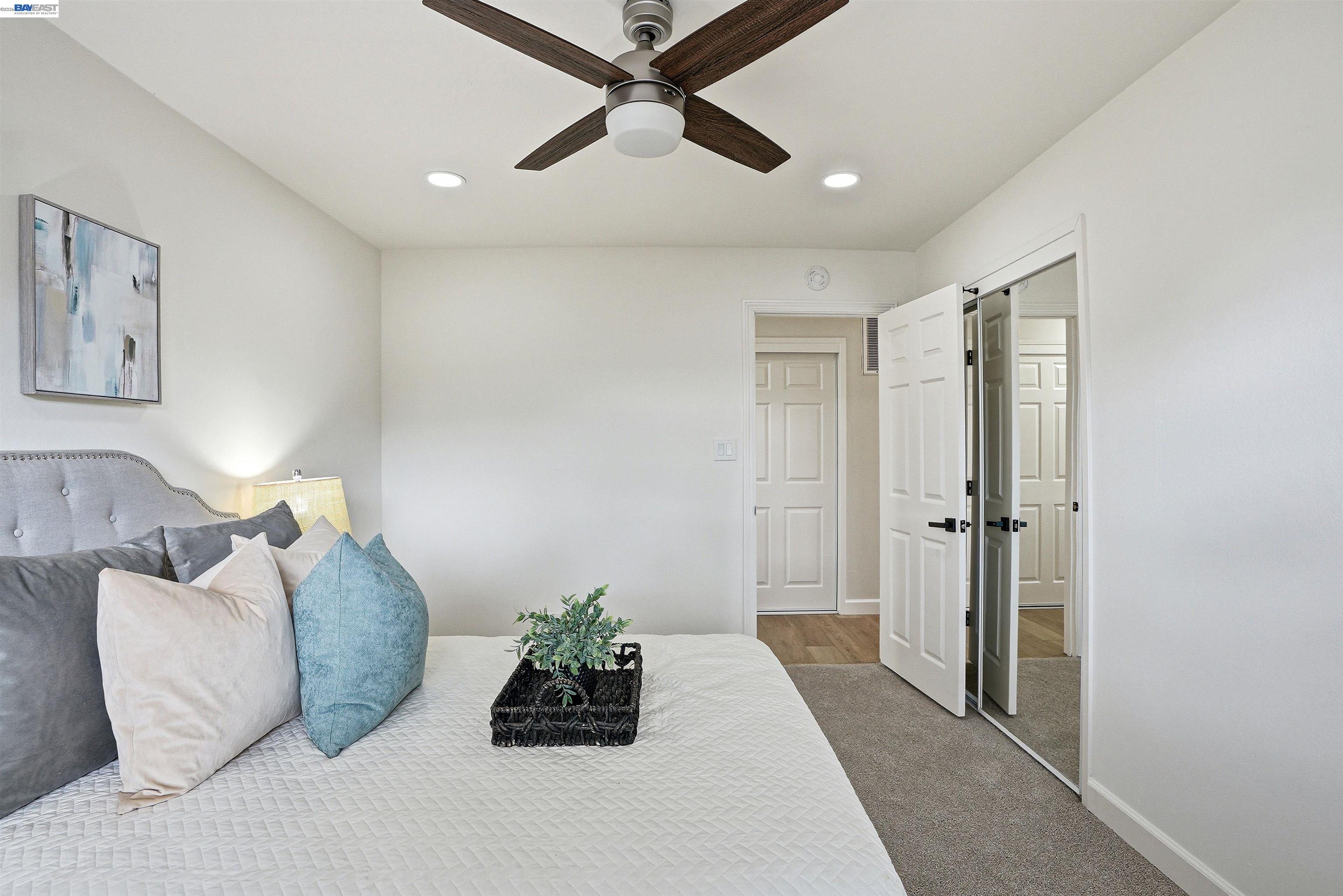 6738 Rancho Court Pleasanton, CA 94588 - Photo 18 of 33 a bedroom with a bed and a chandelier
