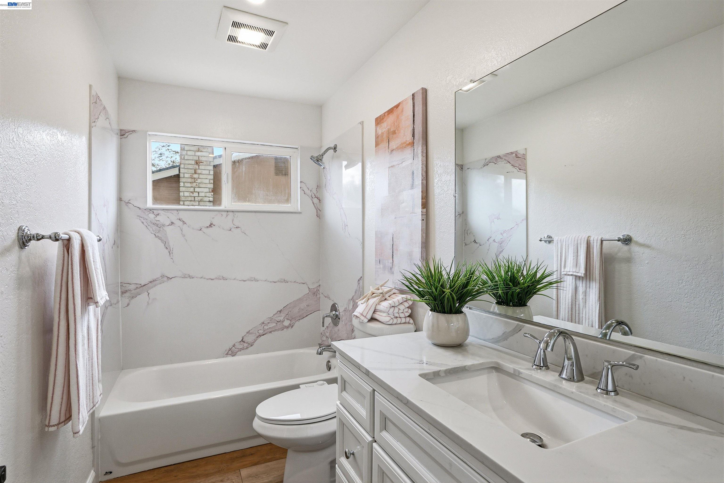 6738 Rancho Court Pleasanton, CA 94588 - Photo 19 of 33 a bathroom with a granite countertop sink toilet and shower
