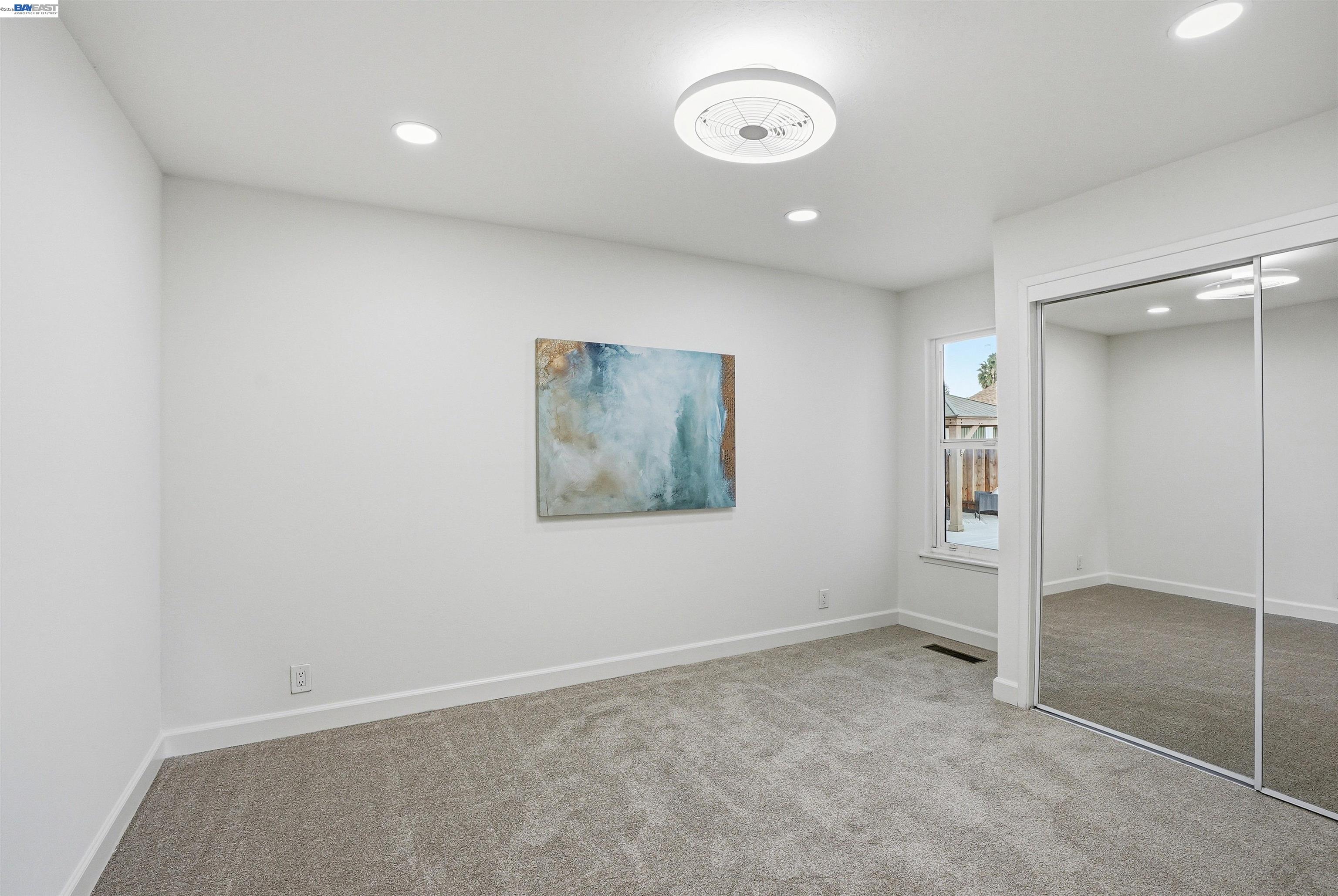 6738 Rancho Court Pleasanton, CA 94588 - Photo 22 of 33 an empty room with closet and windows