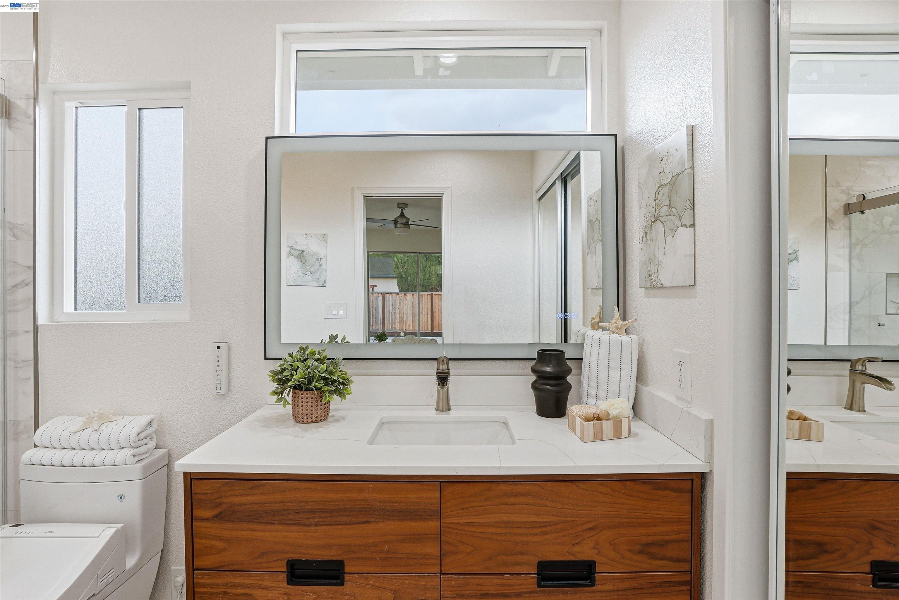 6738 Rancho Court Pleasanton, CA 94588 - Photo 27 of 33 a bathroom with a sink and a mirror