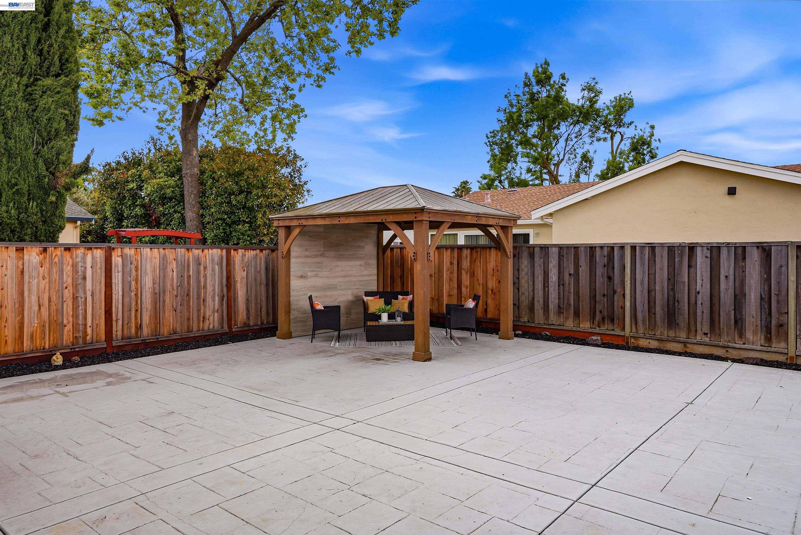 6738 Rancho Court Pleasanton, CA 94588 - Photo 30 of 33 a view of a chairs and table in the back yard of the house