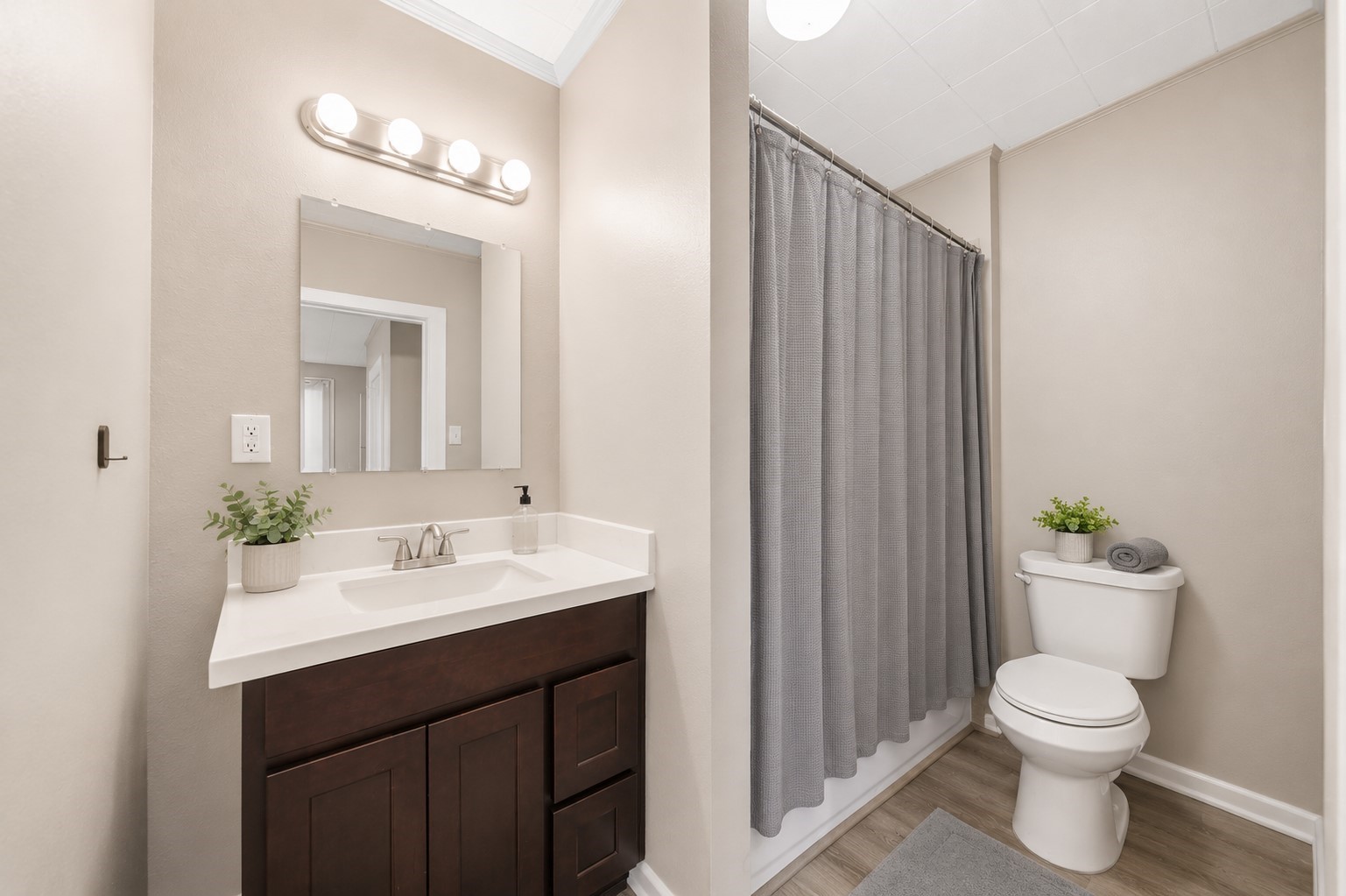 1302 20th Street Huntsville, TX 77340 - Photo 16 of 26 a bathroom with a toilet a sink and a mirror