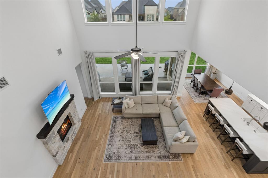 566 Broadleaf Way Haslet, TX 76052 - Photo 1 of 38 Open-concept living space with soaring ceilings and hardwood flooring throughout