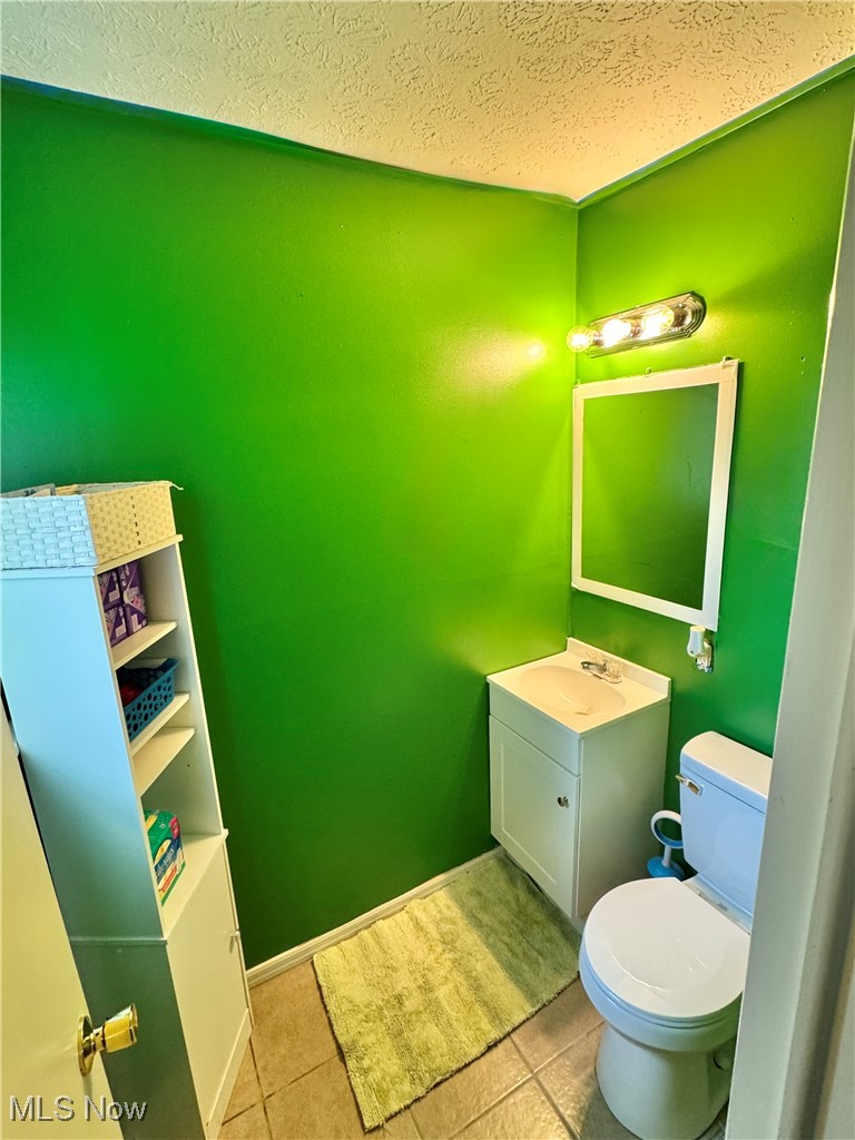 5945 Randy Road Bedford Heights, OH 44146 - Photo 13 of 13 Bathroom with vanity, tile patterned flooring, and a textured ceiling