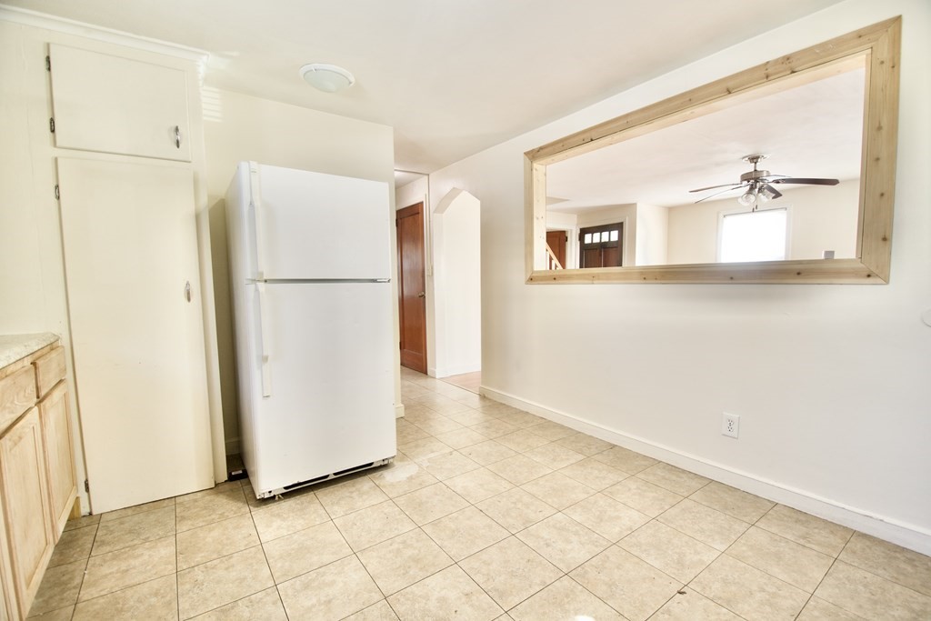 1046 Liberty Street Springfield, MA 01104 - Photo 4 of 19 a view of a kitchen with white cabinets and refrigerator