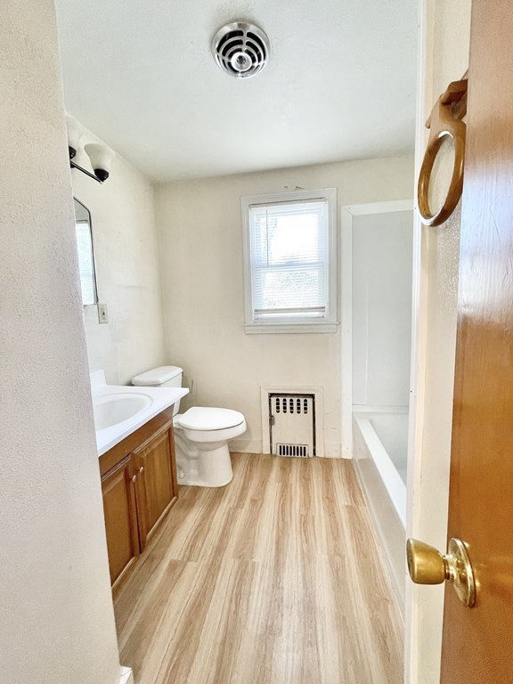 1046 Liberty Street Springfield, MA 01104 - Photo 8 of 19 a bathroom with a sink a toilet and shower curtain