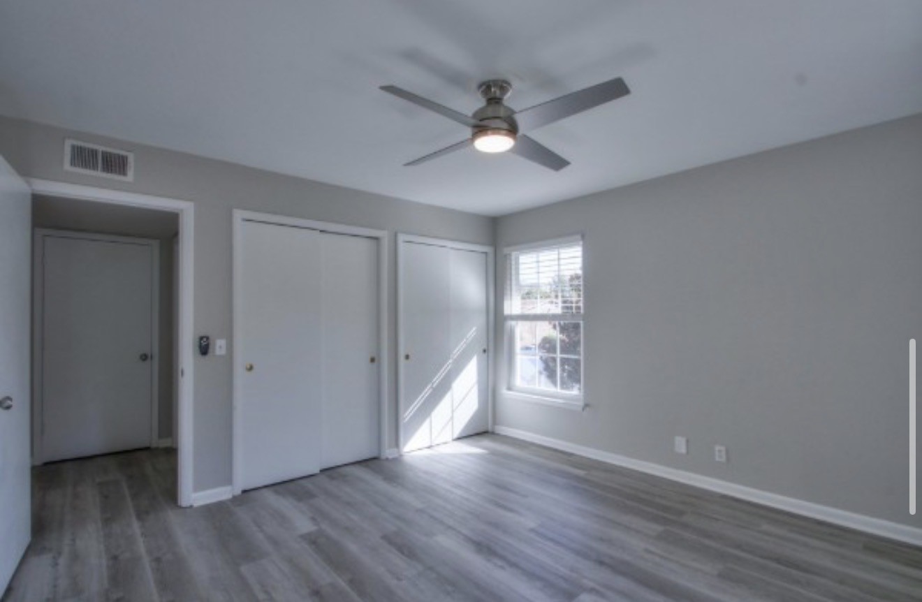 2116 Hobbs Road, Unit M5 Nashville, TN 37215 - Photo 11 of 18 a view of an empty room with wooden floor and a window