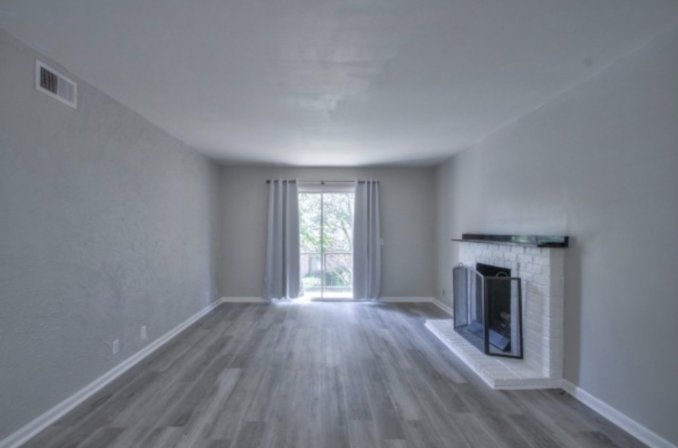 2116 Hobbs Road, Unit M5 Nashville, TN 37215 - Photo 6 of 18 an empty room with wooden floor fireplace and windows