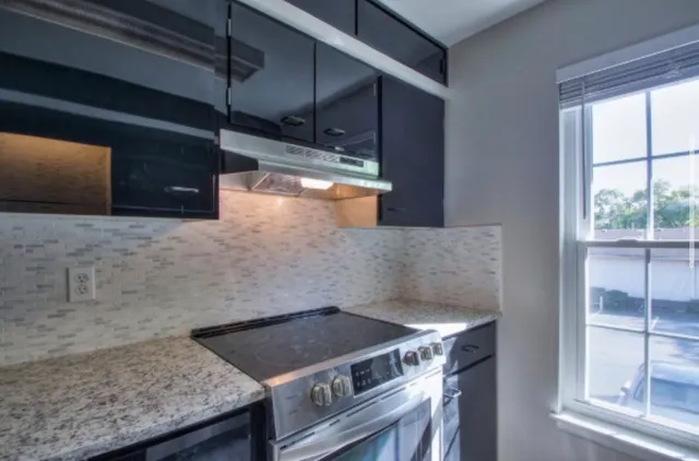 a stove top oven sitting inside of a kitchen