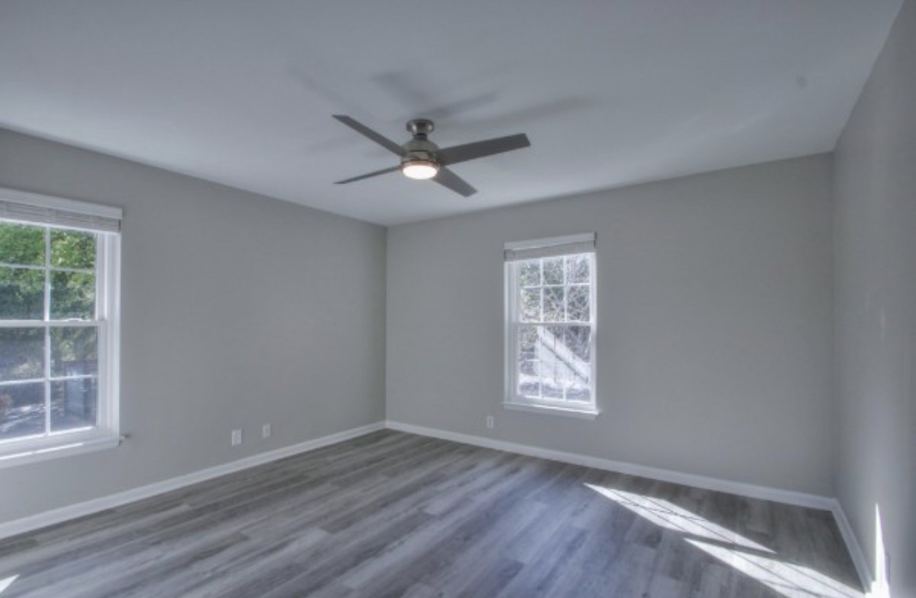 2116 Hobbs Road, Unit M5 Nashville, TN 37215 - Photo 10 of 18 an empty room with wooden floor ceiling fan and windows