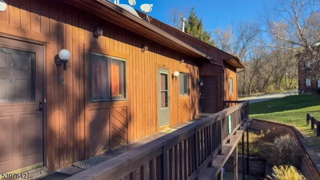 a view of balcony with wooden floor and fence