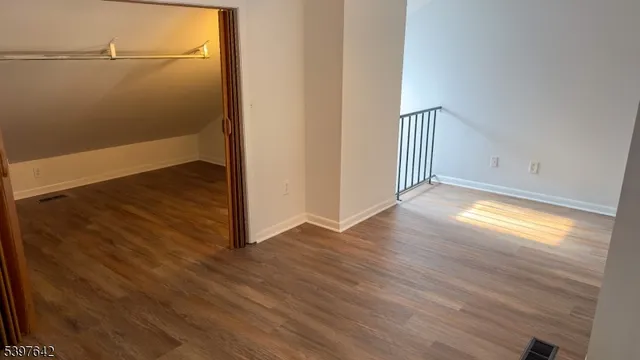 a view of a room with wooden floor