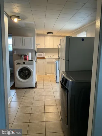a kitchen with a stove a refrigerator and cabinets