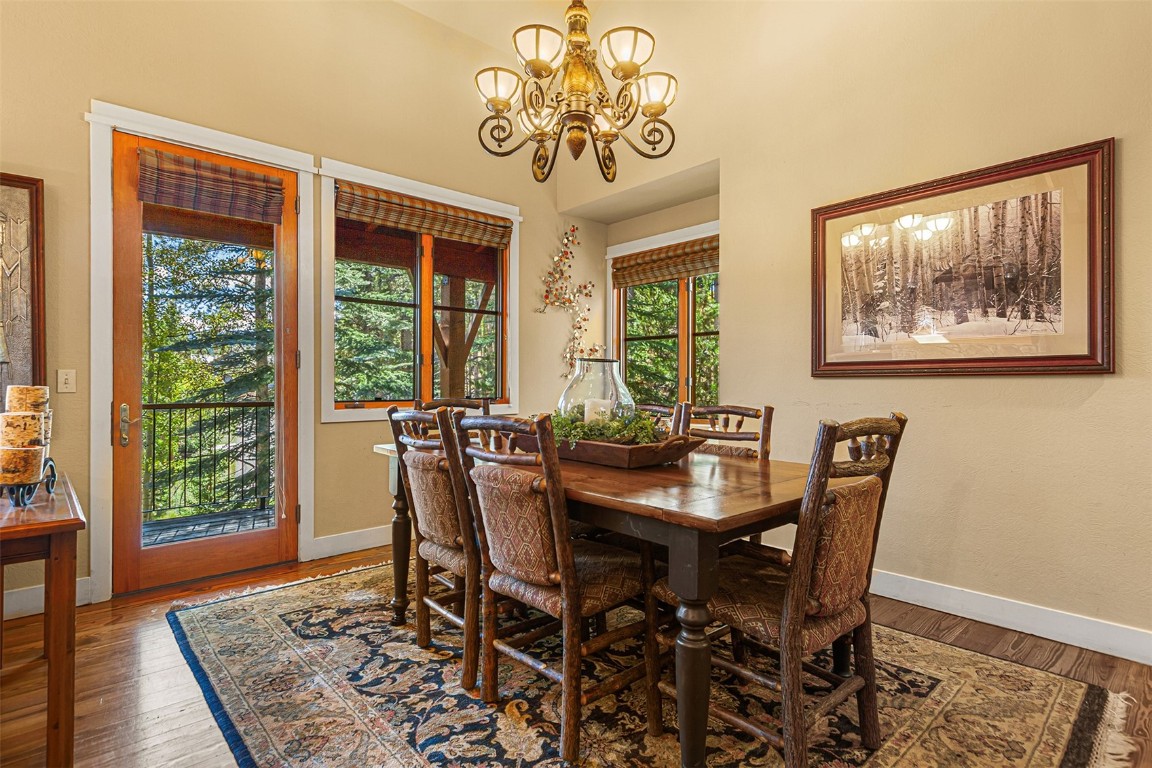 55 Westridge Road, Unit 55 Breckenridge, CO 80424 - Photo 12 of 42 a view of a dining room with furniture window and wooden floor