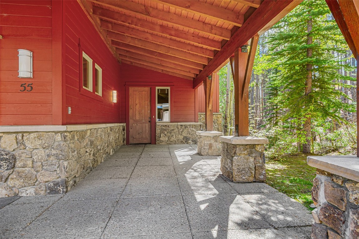 55 Westridge Road, Unit 55 Breckenridge, CO 80424 - Photo 17 of 42 a view of a patio with table and chairs and potted plants