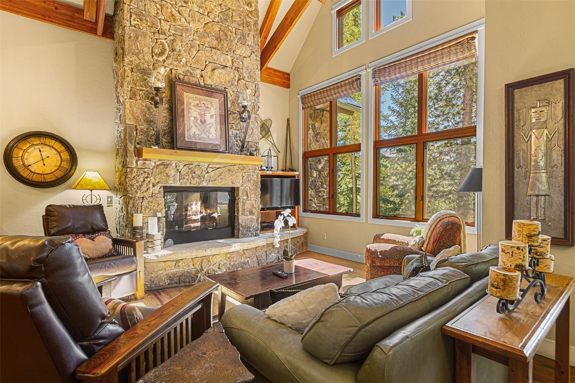 55 Westridge Road, Unit 55 Breckenridge, CO 80424 - Photo 2 of 42 a living room with furniture a fireplace and a large window