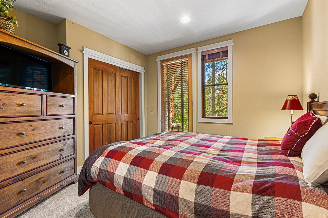 55 Westridge Road, Unit 55 Breckenridge, CO 80424 - Photo 29 of 42 a bedroom with a bed and wooden floor