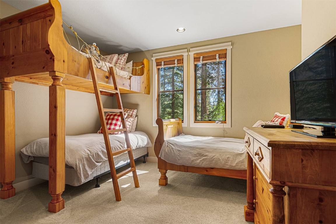 55 Westridge Road, Unit 55 Breckenridge, CO 80424 - Photo 32 of 42 a bedroom with a bed and a table